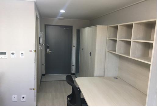 Desk and storage in a Soolim Hall twin room, shown as a room-layout example
